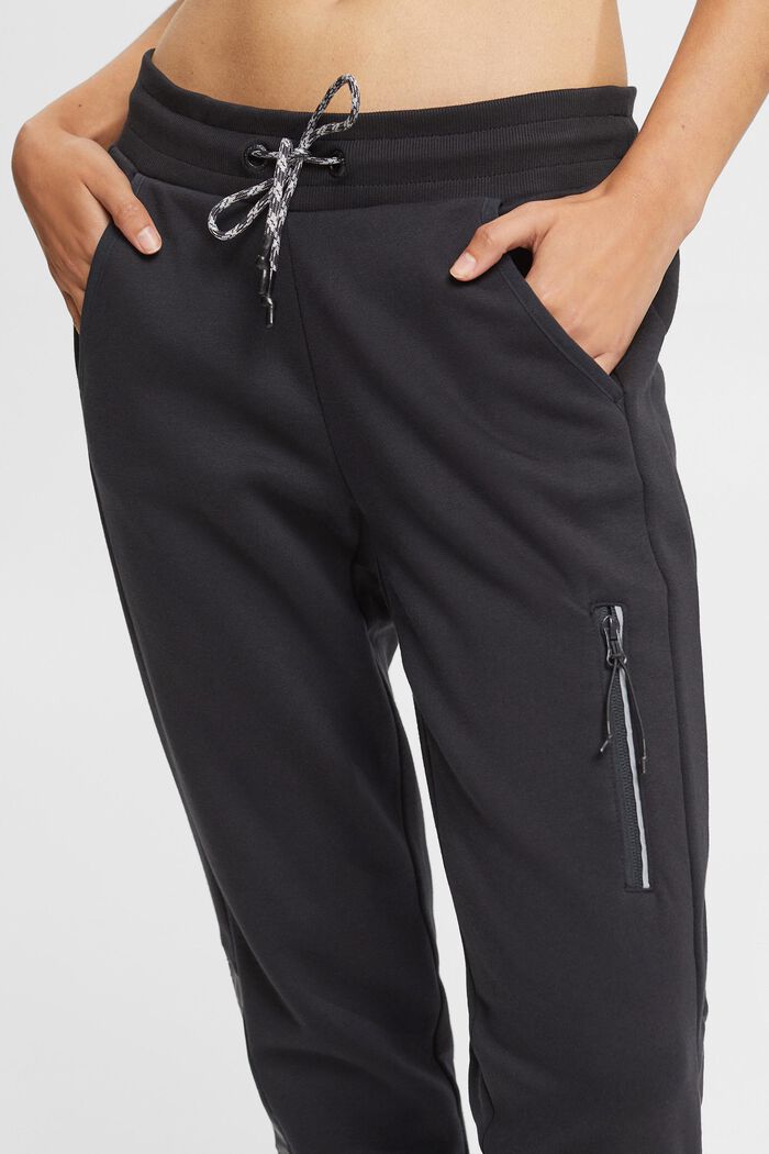 Teplákové kalhoty s kapsou na nohavicích, BLACK, detail image number 0
